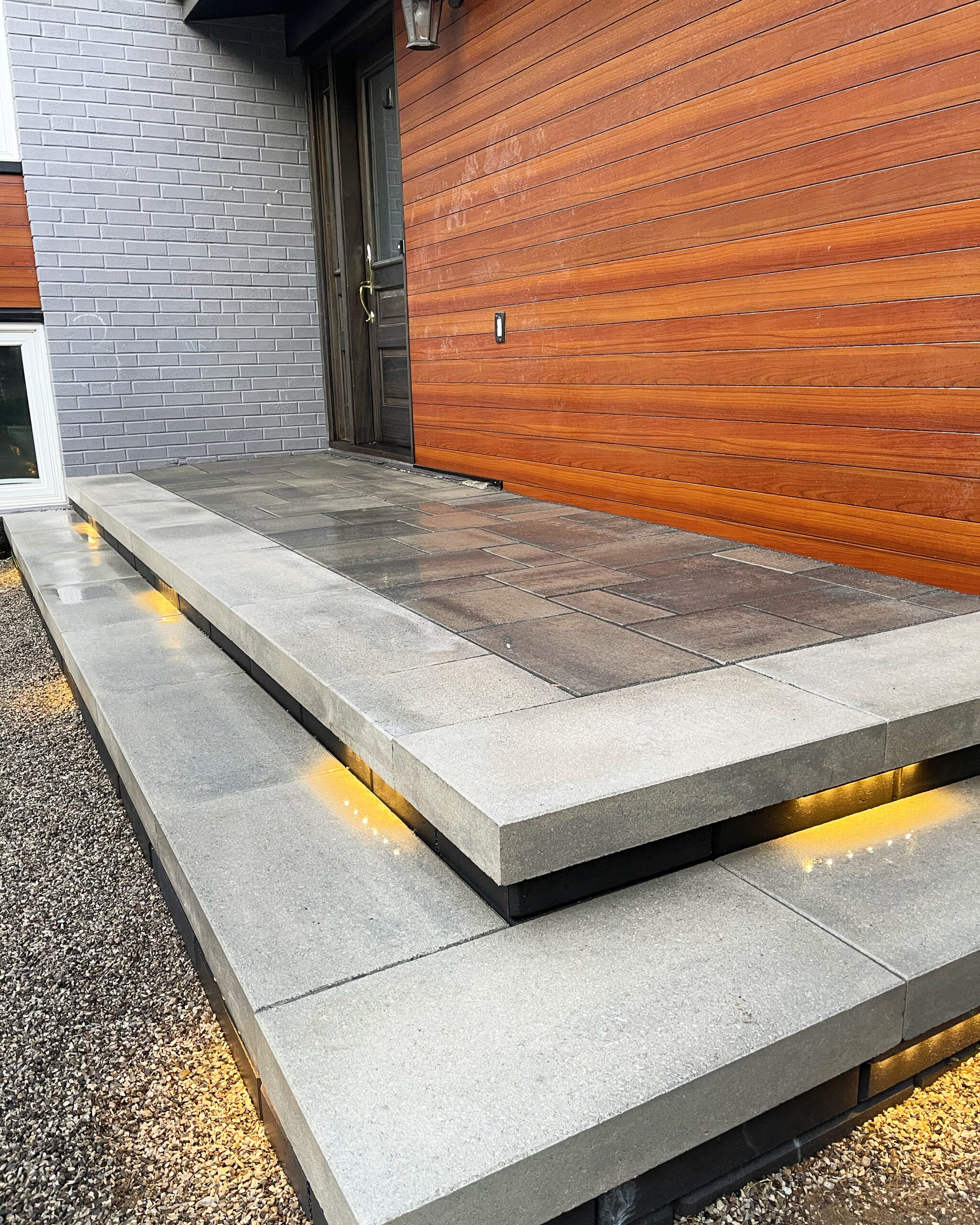 Milton Stone interlocking entrance reference with broad steps and recessed lighting