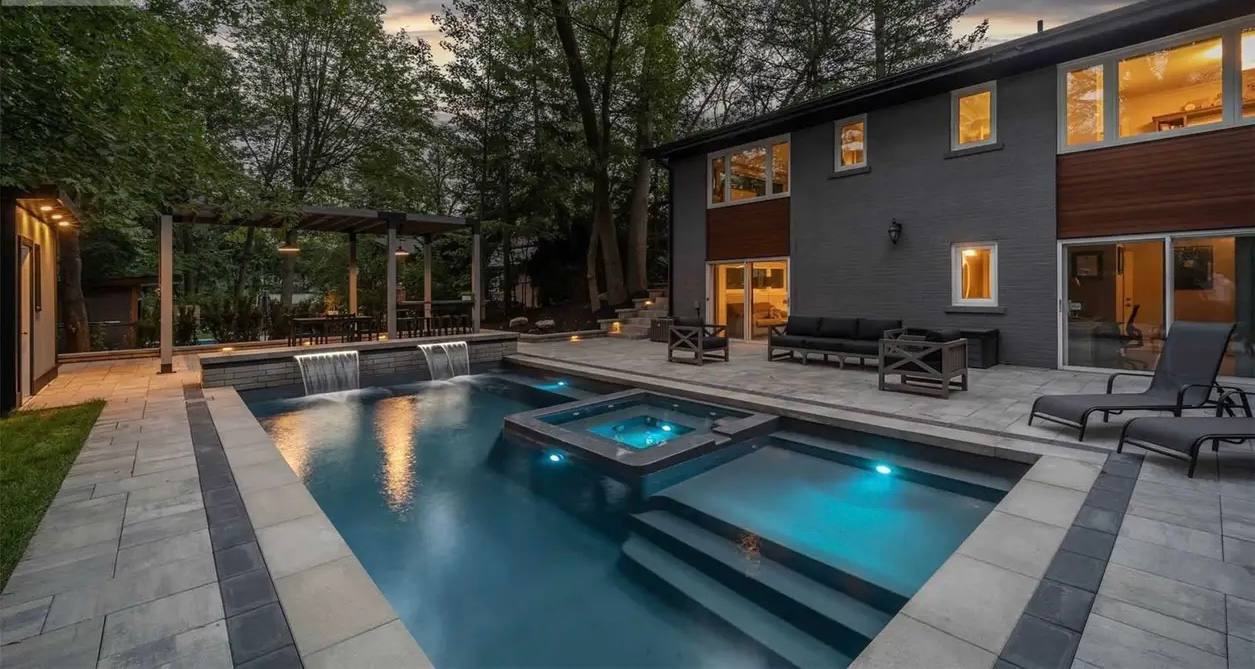 Custom pool and outdoor living space with stone patio built by Milton Stone in the Greater Toronto Area