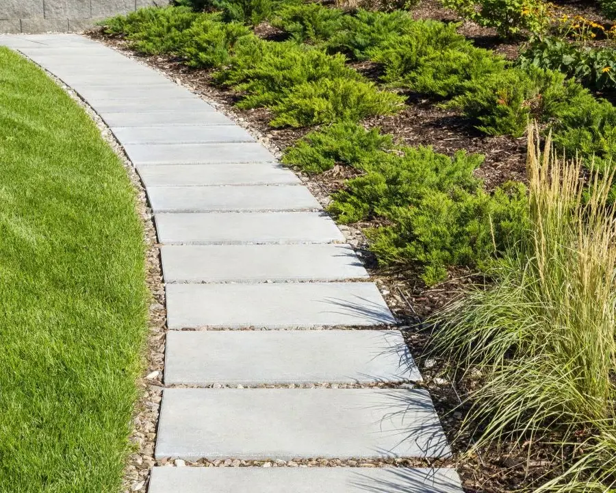 Techo-Bloc Blu 60 Smooth in Greyed Nickel on a curved garden walkway; manufacturer photograph