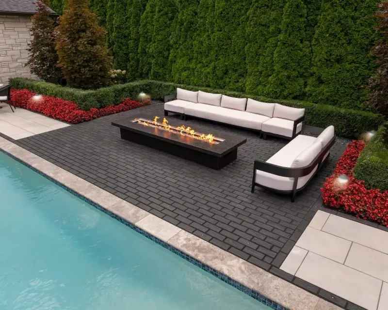 Techo-Bloc Mika paving in an outdoor lounge beside a pool; manufacturer reference photograph