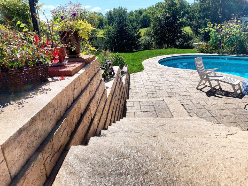 Finished poolside steps and retaining wall in Milton