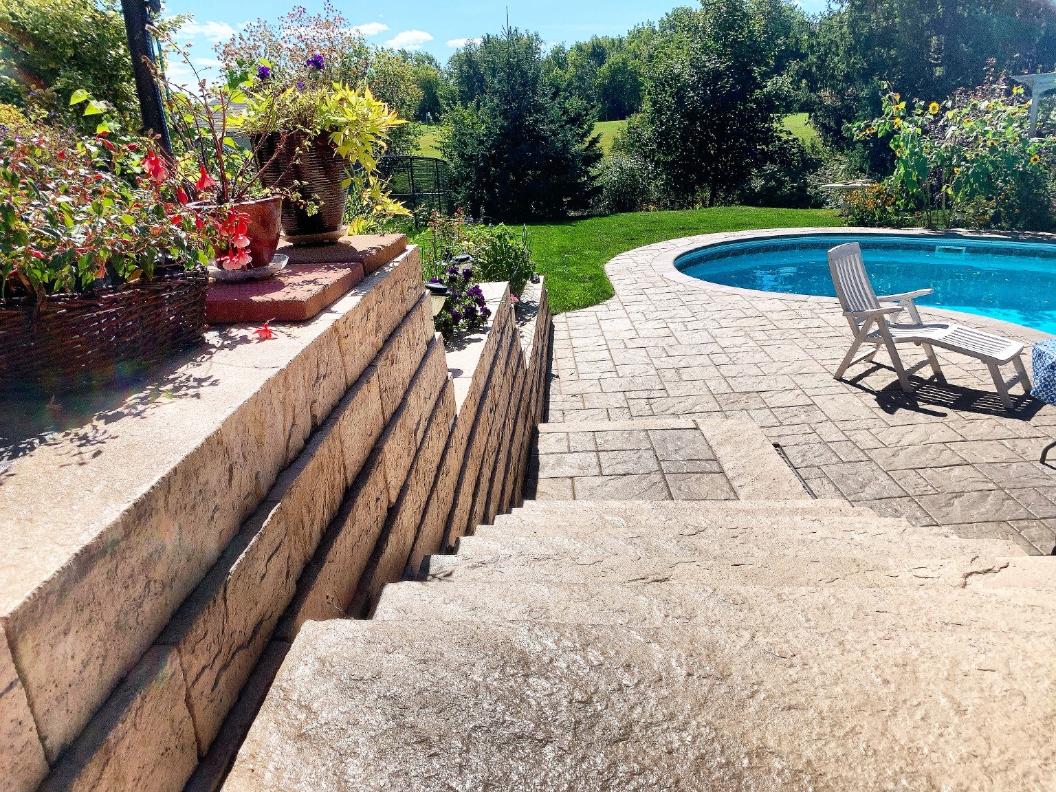 Completed retaining wall and steps leading to the pool deck in Milton