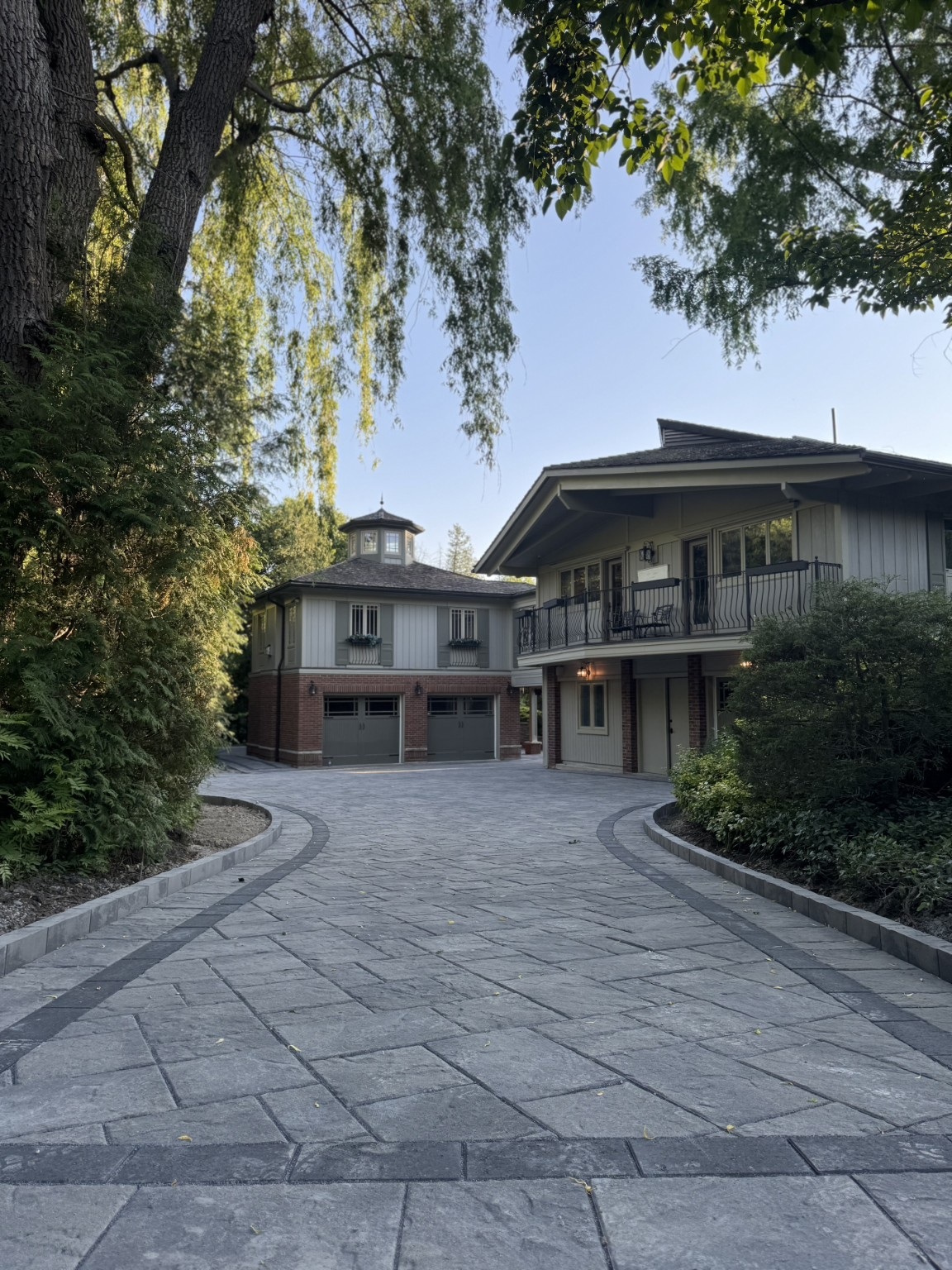 The finished driveway framed by mature trees